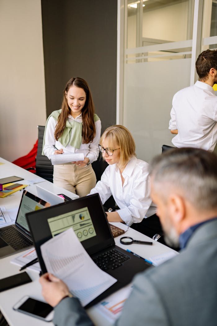 about-01 Colleagues collaborating on project in office setting, diverse team dynamics.